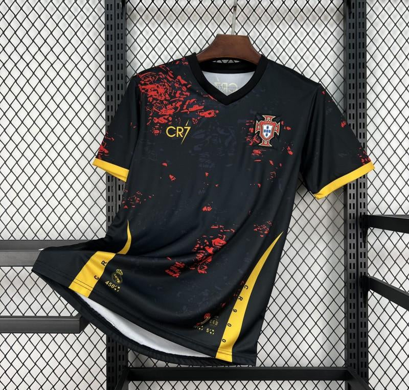 Black sports jersey with red and yellow accents, featuring a logo and text, on a black metal rack.