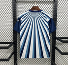 Blue and white striped shirt on a hanger against a black metal grid background